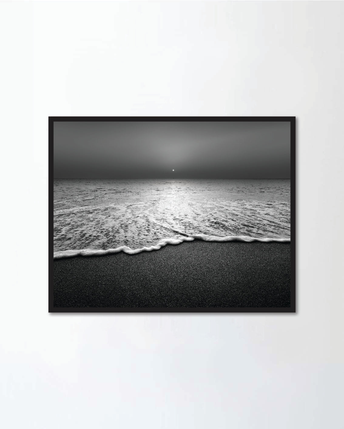 Wave and sandy beach in black and white