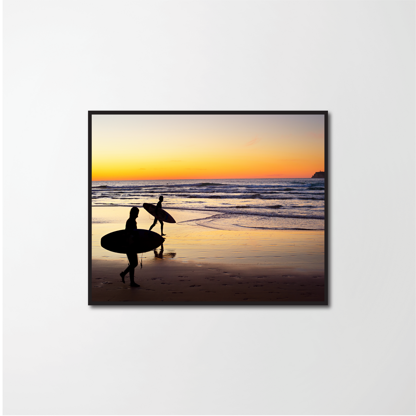 Two surfers running on the beach