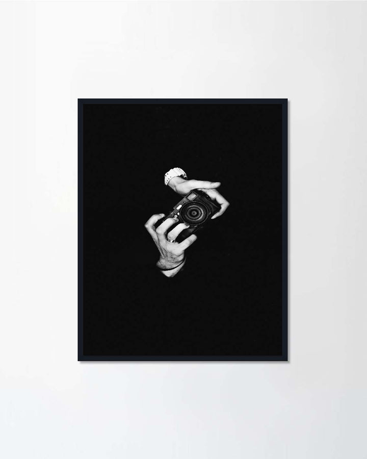 A man photographer holding a camera