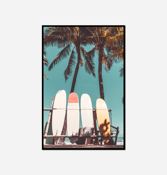 three surfboards sitting beach palm trees