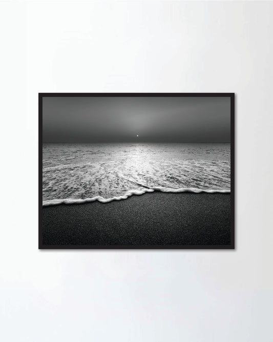 Wave and sandy beach in black and white