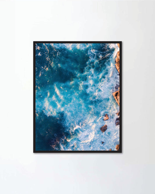 Aerial view of wave foam and rock