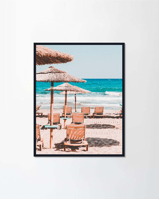 Empty sunbeds and straw umbrellas