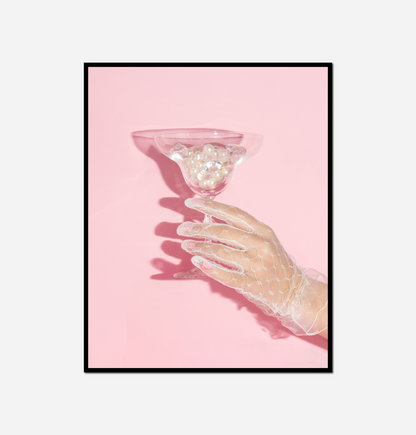 Someone holding glass liquid inside